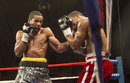 Lamont Peterson, left, works Kendall Holt against the ropes in the eighth round