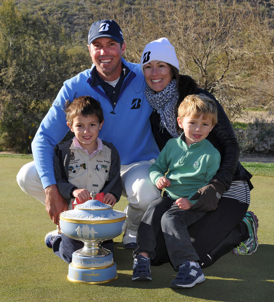 Matt Kuchar celebrates with the trophy as he poses with his family