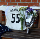 Flowers start to collect in memory of Tom Maynard