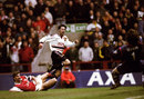 Ryan Giggs of Manchester United beats the despairing lunge of Tony Adams of Arsenal to drive the ball past David Seaman to score the winner in the FA Cup Semi Final match played at Villa Park in Birmingham. Manchester United won the game 2-1 after extra-time