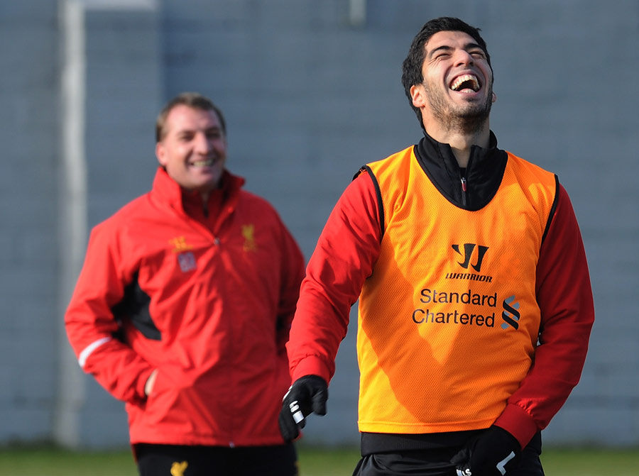 Brendan Rodgers and Luis Suarez share a joke during a Liverpool training session