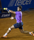 Rafael Nadal slides for a backhand
