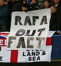 Chelsea fans hold a banner in protest