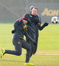 Tom Cleverley catches Wayne Rooney with a boot