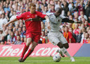 John Arne Riise and Marlon Harewood challenge for the ball