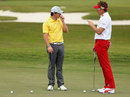 Rory McIlroy chats with Ian Poulter