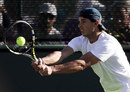 Rafael Nadal hits a backhand in practice