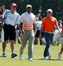 Tiger Woods walks alongside Rory McIlroy