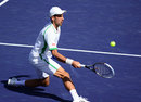 Novak Djokovic sliding for a volley