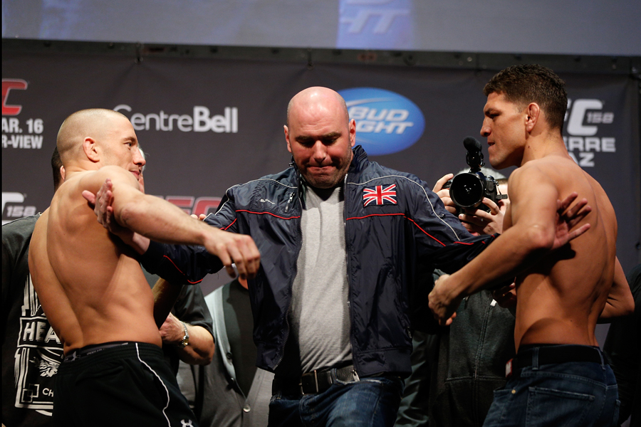 Dana White steps between Georges St-Pierre and Nick Diaz