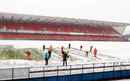 Ground staff help clear snow away from Windsor Park