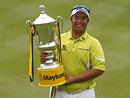 Kiradech Aphibarnrat poses for photographers with his trophy
