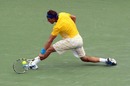 Rafael Nadal reaches low to return the ball