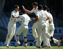 Trent Boult is mobbed by his team-mates after dismissing Joe Root