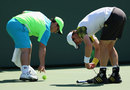 Andy Murray tying up his shoelaces before serving