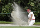 Ian Poulter splashes out of a bunker