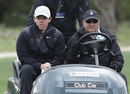 Rory McIlroy catches a lift on a golf cart