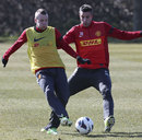 Robin van Persie and Tom Cleverley battle during a first team training session