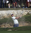 Rory McIlroy splashes out of a bunker