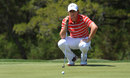 Rory McIlroy lines up his putt on the fifth hole