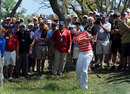 Rory McIlroy chips out of the rough at the fifth hole