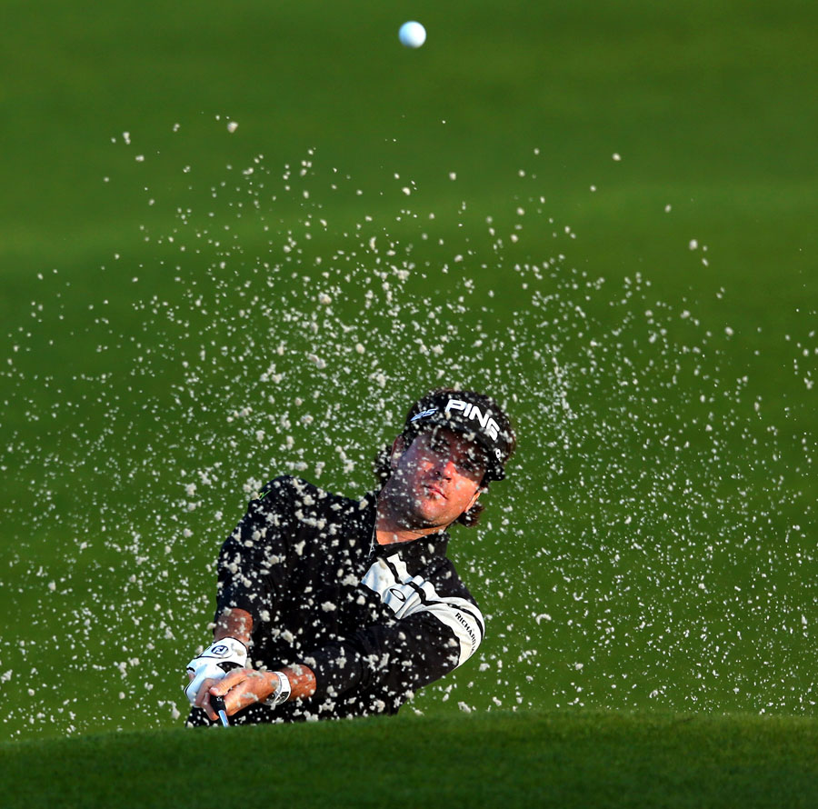 Bubba Watson hits out of a bunker during a practice round