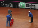 Ground staff mop the court in Switzerland