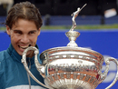 Rafael Nadal bites the trophy at the Barcelona Open