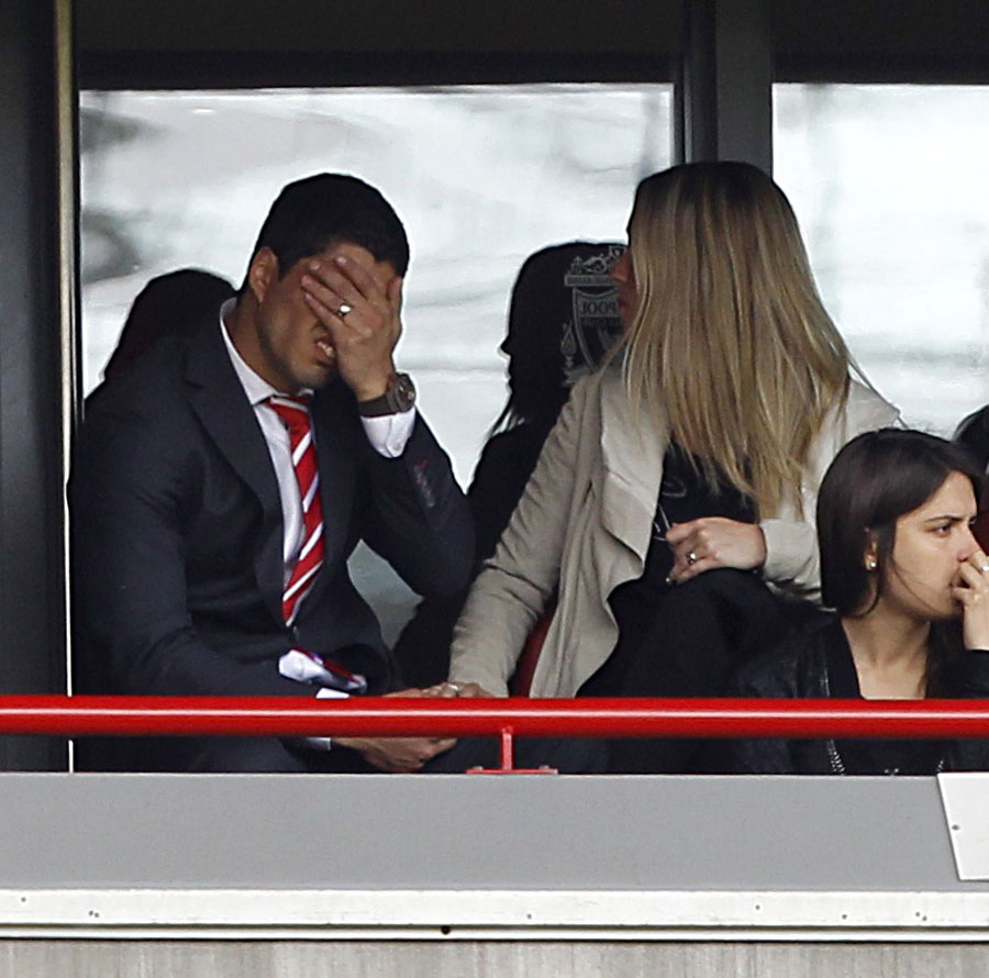 Luis Suarez barely watches from the stands