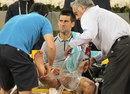Novak Djokovic receives treatment on his ankle