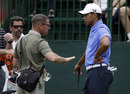 Tiger Woods talks with coach Sean Foley during practice