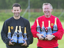 Sir Alex Ferguson and Ryan Giggs hold eight bottles of champagne for their eight titles won