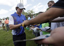 Rory McIlroy signs autographs for spectators
