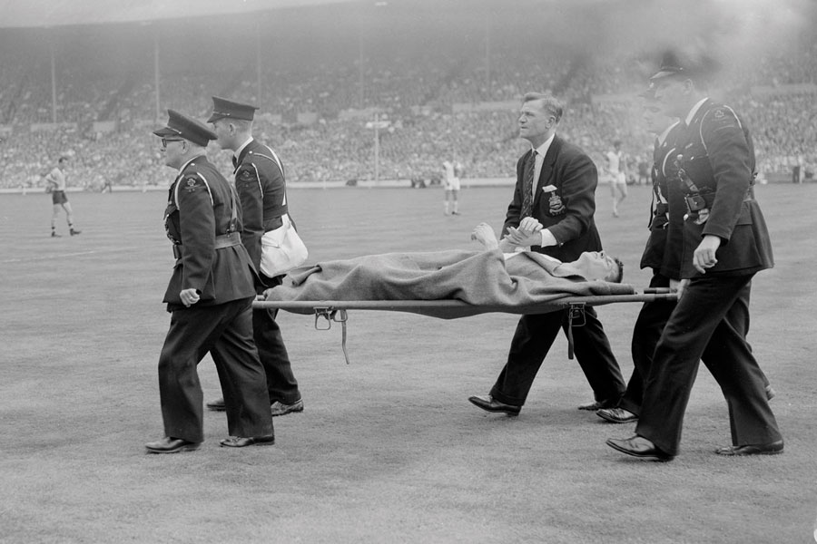 Dave Whelan is stretchered off after he breaks his leg
