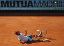Rafael Nadal slides on the court in celebration