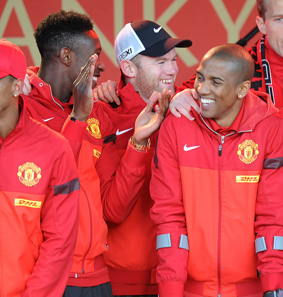 Danny Welbeck, Wayne Rooney and Ashley Young celebrate on stage