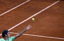 Roger Federer throws the ball in the air for a serve