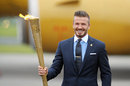 David Beckham holds the Olympic torch