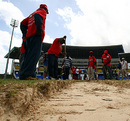 Groundsmen dig beneath the surface of the Antigua pitch and find a sandpit