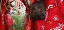 Djimi Traore kisses the trophy as he celebrates with team-mates