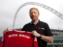Boris Becker holds a Bayern Munich shirt outside Wembley Stadium

