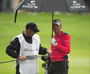 Ian Poulter and caddie Terry Mundy shelter from the rain