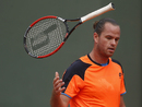 Xavier Malisse throws his racket in frustration