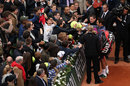 Roger Federer signs autographs for the fans at the French Open