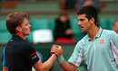David Goffin shakes hands with Novak Djokovic