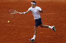 Roger Federer plays a forehand on the run