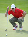 Rory McIlroy eyes up a putt