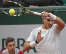 Rafael Nadal plays a high forehand