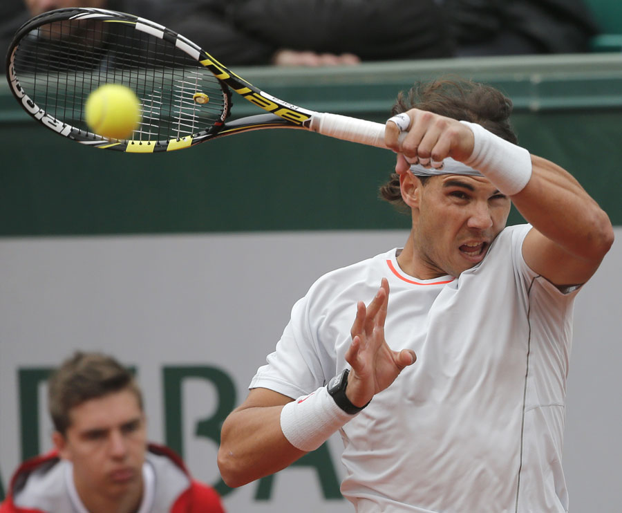 Rafael Nadal plays a high forehand