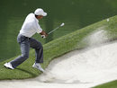 Tiger Woods plays out of the bunker
